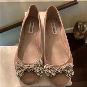 Blush suede flats with rhinestone bow detail.